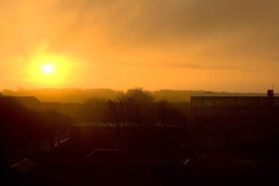 An amber sunrise seen from a kitchen window